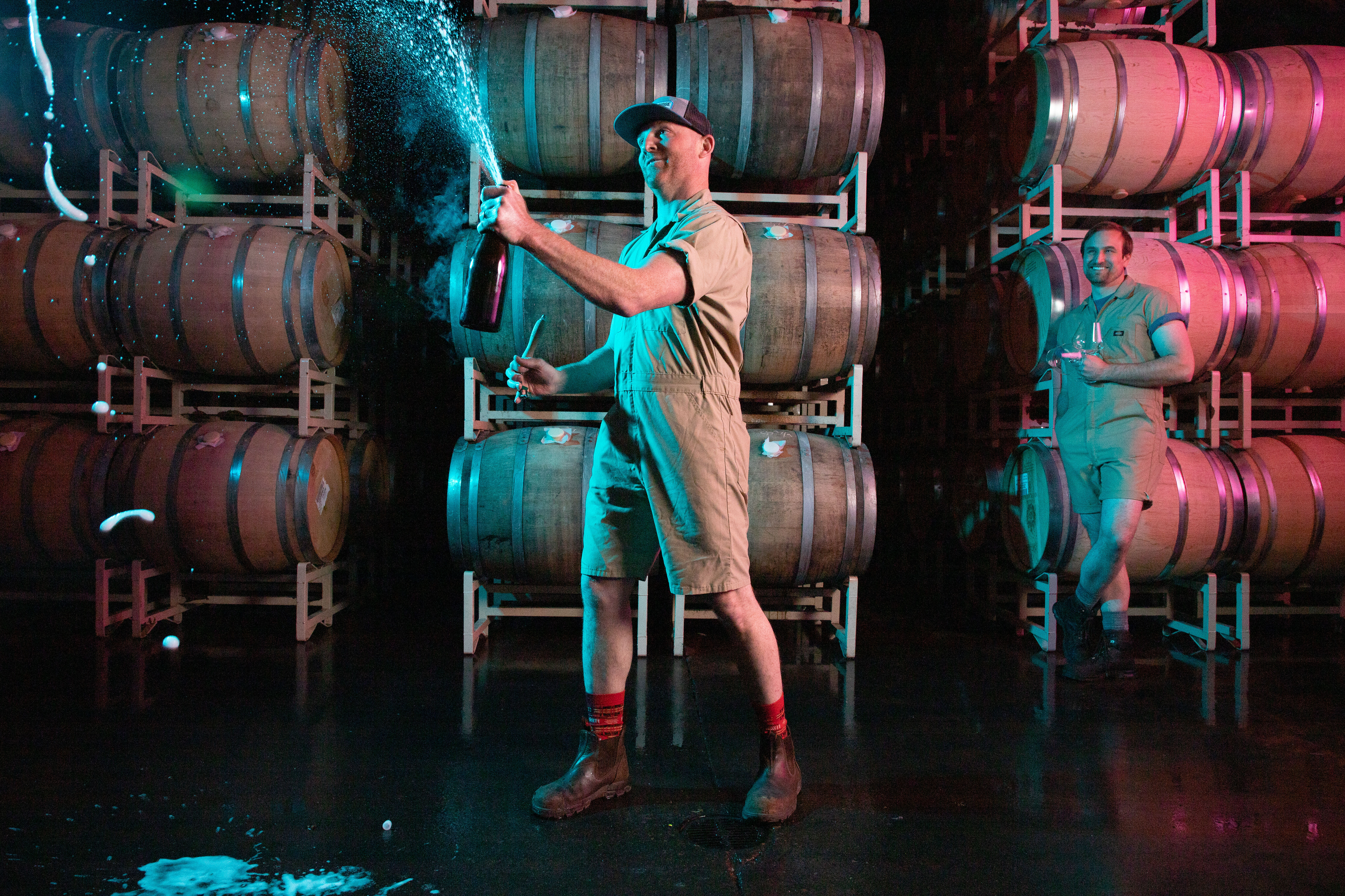 Gran Moraine Winemaker Shane Moore with glass of wine and a bottle of Gran Moraine